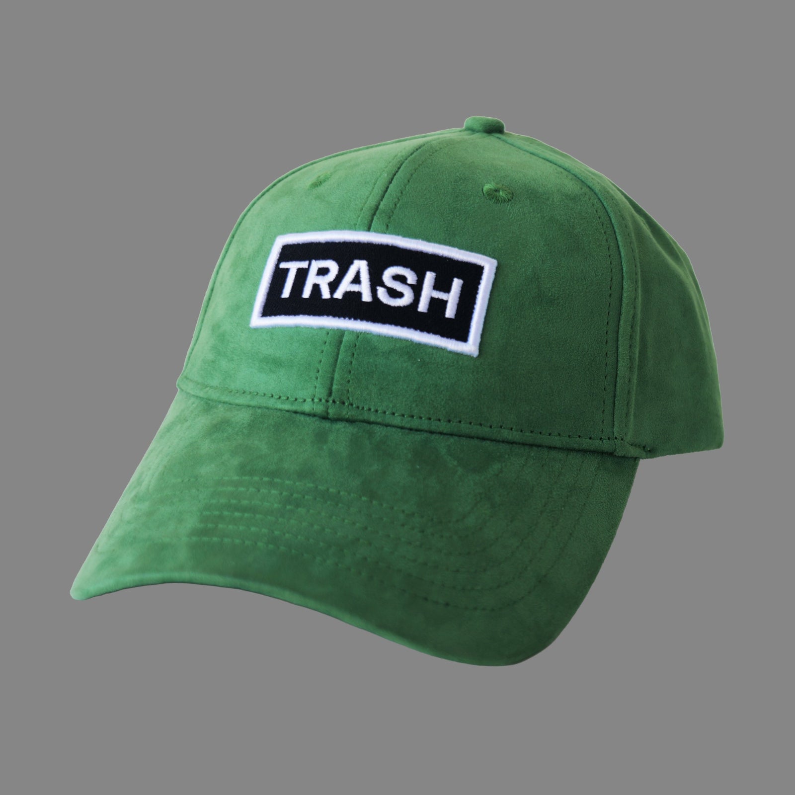 Front view of bABP "TRASH" green eco-suede hat with a black and white embroidered logo patch, Signature Collection